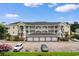 Attractive condo building featuring private garages and ample parking at 4872 Dahlia Ct. # 305, Myrtle Beach, SC 29577