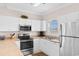 Bright kitchen featuring stainless steel appliances and white cabinets at 4872 Dahlia Ct. # 305, Myrtle Beach, SC 29577