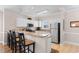 Bright kitchen with stainless steel refrigerator and a breakfast bar with three chairs at 4872 Dahlia Ct. # 305, Myrtle Beach, SC 29577