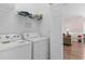 Bright laundry area with a full-sized washer and dryer plus shelving for storage at 4872 Dahlia Ct. # 305, Myrtle Beach, SC 29577