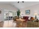 Bright living room with comfortable seating, a wooden coffee table, and a sliding door to the balcony at 4872 Dahlia Ct. # 305, Myrtle Beach, SC 29577