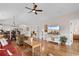 Spacious living room showcasing hardwood floors, dining area, and modern TV display at 4872 Dahlia Ct. # 305, Myrtle Beach, SC 29577