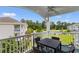 Balcony with a fan, outdoor dining table, and a view of lush landscaping and pool at 4872 Dahlia Ct. # 305, Myrtle Beach, SC 29577