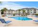 Exterior shot of community pool featuring lounge chairs and nearby condo buildings at 4872 Dahlia Ct. # 305, Myrtle Beach, SC 29577