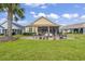 Beautiful backyard with a screened-in porch and a brick patio, perfect for outdoor entertaining at 492 Grand Cypress Way, Murrells Inlet, SC 29576