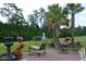 A serene backyard provides an outdoor seating area and a water feature at 492 Grand Cypress Way, Murrells Inlet, SC 29576