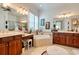 A luxurious bathroom with double vanities, makeup vanity, and a corner soaking tub at 492 Grand Cypress Way, Murrells Inlet, SC 29576