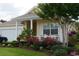 Charming single-Gathering home with lush landscaping, front porch and two-car garage at 492 Grand Cypress Way, Murrells Inlet, SC 29576
