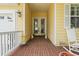 Inviting front porch with brick flooring, decorative statues, and ample space for seating at 492 Grand Cypress Way, Murrells Inlet, SC 29576
