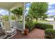 Charming front porch with brick flooring, rocking chairs, and views of the street at 492 Grand Cypress Way, Murrells Inlet, SC 29576