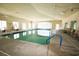 A large indoor swimming pool featuring ample lighting and lounge chairs for relaxation at 492 Grand Cypress Way, Murrells Inlet, SC 29576