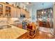 A gourmet kitchen boasts custom cabinetry, stainless appliances, and a unique dining space at 492 Grand Cypress Way, Murrells Inlet, SC 29576