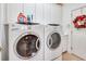 A well-equipped laundry room offers modern washer and dryer units and ample cabinet space at 492 Grand Cypress Way, Murrells Inlet, SC 29576