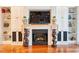 A cozy fireplace with decorative mantel sits between two built-in cabinets at 492 Grand Cypress Way, Murrells Inlet, SC 29576