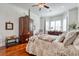 A spacious main bedroom featuring hardwood floors, a decorative bed, and a sitting area at 492 Grand Cypress Way, Murrells Inlet, SC 29576