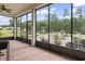 Screened in patio with red brick flooring and views of the green backyard at 492 Grand Cypress Way, Murrells Inlet, SC 29576