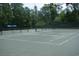 Outdoor tennis courts surrounded by trees at 492 Grand Cypress Way, Murrells Inlet, SC 29576