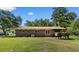 Expansive backyard featuring mature trees, lush green grass, and a brick exterior home at 5 Dogwood St., Hemingway, SC 29554