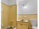Charming bathroom features yellow tile, vintage fixtures, and a classic design at 5 Dogwood St., Hemingway, SC 29554