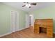 Cozy bedroom featuring a ceiling fan, wood-look floors, and a unique wooden roll top desk at 5 Dogwood St., Hemingway, SC 29554