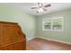 Cozy bedroom features wood floors, green walls and natural light at 5 Dogwood St., Hemingway, SC 29554