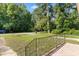 The front yard is spacious with mature trees and a combination of lawn and natural growth at 5 Dogwood St., Hemingway, SC 29554