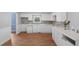 Kitchen with white cabinetry, stone backsplash and wood look floors at 5 Dogwood St., Hemingway, SC 29554