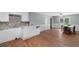 Open kitchen flows into a dining area with a door to the backyard and hardwood floors at 5 Dogwood St., Hemingway, SC 29554