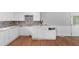 Kitchen with white cabinets, decorative stone backsplash and white table at 5 Dogwood St., Hemingway, SC 29554