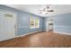 Inviting living room with light blue walls, wood-look flooring, and a ceiling fan at 5 Dogwood St., Hemingway, SC 29554