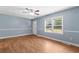 Cozy living room with wood-look flooring, light blue walls, and natural light from the window at 5 Dogwood St., Hemingway, SC 29554