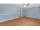 Bright, airy living room featuring light blue walls, wood-look flooring, and a ceiling fan at 5 Dogwood St., Hemingway, SC 29554