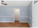 Open living room showing wall trim and door leading to the kitchen at 5 Dogwood St., Hemingway, SC 29554