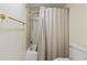 Bathroom with shower-tub combo with beige tiling, shower curtain, and toilet at 5515 North Ocean Blvd. # 308, Myrtle Beach, SC 29577