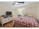 Comfortable bedroom with a ceiling fan, dresser and queen-sized bed for a cozy and restful stay at 5515 North Ocean Blvd. # 308, Myrtle Beach, SC 29577