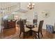 Open-concept dining room with hardwood floors, glass table, and staircase at 5515 North Ocean Blvd. # 308, Myrtle Beach, SC 29577