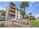 The Anchorage condos building exterior with sign, palm trees, and parking at 5515 North Ocean Blvd. # 308, Myrtle Beach, SC 29577