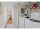 Practical laundry area with washer, dryer, and storage shelving at 5515 North Ocean Blvd. # 308, Myrtle Beach, SC 29577