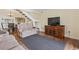 Spacious living room with hardwood floors, a TV, and a staircase at 5515 North Ocean Blvd. # 308, Myrtle Beach, SC 29577