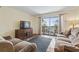 Inviting living room with balcony access, a TV, and comfortable seating at 5515 North Ocean Blvd. # 308, Myrtle Beach, SC 29577
