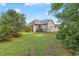 Picturesque backyard view, showcasing a well-maintained lawn and exterior of the home framed by lush greenery at 56 Willowbend Dr., Murrells Inlet, SC 29576