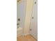Bathroom doorway leading to bathtub with shower, tile floor and white door at 56 Willowbend Dr., Murrells Inlet, SC 29576