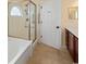 Bathroom view features a shower and separate tub, showcasing tile floors, and neutral wall color at 56 Willowbend Dr., Murrells Inlet, SC 29576