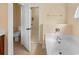 Bright bathroom boasts a large tub and is adjoined to the toilet and walk-in closet at 56 Willowbend Dr., Murrells Inlet, SC 29576