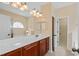 Bathroom boasts a double vanity with tub, a large mirror, and a door leading to the walk-in closet at 56 Willowbend Dr., Murrells Inlet, SC 29576