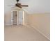 Spacious carpeted bedroom with fan is adjoined to walk-in closets and bathrooms, offering comfort and convenience at 56 Willowbend Dr., Murrells Inlet, SC 29576