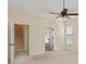 Bedroom boasts tray ceiling and fan, adjoining stairs and bathroom, offering privacy and convenience at 56 Willowbend Dr., Murrells Inlet, SC 29576