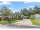 Charming brick home with dark shutters and a manicured lawn with mature trees, complimented with a wide concrete driveway at 56 Willowbend Dr., Murrells Inlet, SC 29576