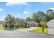 Charming brick home featuring a manicured lawn, mature trees and a paved driveway at 56 Willowbend Dr., Murrells Inlet, SC 29576