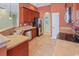Modern kitchen featuring stainless steel appliances, tile flooring, dark wood cabinets and lots of counter space at 56 Willowbend Dr., Murrells Inlet, SC 29576